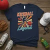 Kickball Legend text with a silhouette of a player kicking a ball against a sunburst background on a navy t-shirt
