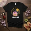 Black t-shirt with white text "KIMONO" below a graphic of a woman in a pink kimono within a yellow sun