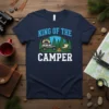 King Of The Camper t-shirt with a graphic of a camper van, trees, campfire, and camping chair