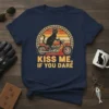 Black cat wearing sunglasses riding a motorcycle with text "Kiss Me If You Dare" on a navy blue t-shirt