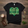 Black t-shirt with "KISS MORE LASSES" repeated in green, forming a heart shape with shamrocks and lips at the bottom