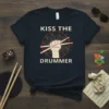 Kiss The Drummer t-shirt design featuring drumsticks held in a fist, with musical notes and radiating lines
