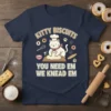 Cute cat baker wearing a chef hat kneading dough with text "Kitty Biscuits You Need Em We Knead Em" and
