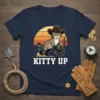 Navy t-shirt featuring a tabby cat dressed as a cowboy, holding a lasso, with the text "KITTY UP" below