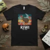 KIWI EST. 1890 T-Shirt featuring a vintage-style graphic of a kiwi bird surrounded by native flowers and retro stripes