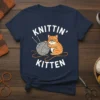 Knittin' Kitten text and graphic of a cute orange tabby cat with glasses knitting with yarn and needles