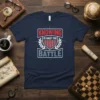 Navy blue t-shirt with the quote "Knowing is Half the Battle" in bold red and grey typography, featuring a shield