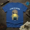 T-shirt with "LA QUE SE AVECINA ???" text above a graphic of an open door revealing a city skyline and