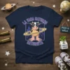 La Vaca Saturno Saturnita text with a cartoon cow in Saturn's rings, set against a cityscape background, on a navy