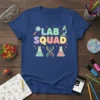 Lab Squad text design with magnifying glass, microscope, beakers, and DNA helix graphic on a navy blue t-shirt