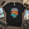 Black t-shirt featuring the Lacanau Ocean Surf logo with a surfer on a wave, sun, and retro design