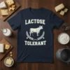 Navy t-shirt with "LACTOSE TOLERANT" text and a cow graphic surrounded by wheat stalks