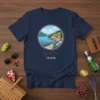 Lago di Como Italia t-shirt design featuring a circular Italian lake scene with buildings and a boat