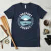 Navy t-shirt with "Lakefont Energy" text and a graphic of a canoeist on a lake at sunset, framed by laurel