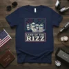 Land of the Rizz T-Shirt featuring stylized portraits of four men in sunglasses with fireworks and patriotic text