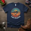 Las Cruces t-shirt design featuring a roadrunner, desert landscape, mountains, cactus, and hot air balloon in a circular graphic