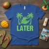 Blue t-shirt with "LATER" text and a green alligator in a hammock between palm trees, perfect for vacation vibes