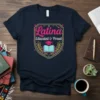 Latina Educated & Proud t-shirt design featuring bold pink text, graduation cap, and open book graphic in a shield emblem