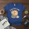 Lazy Cat Lady t-shirt design with a sleeping cat wearing a crown on books, next to a coffee cup