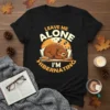 Leave Me Alone I'm Hibernating bear t-shirt design with sleeping bear on pillow, books, and mug