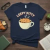 Leepy Kitty T-Shirt with a cute orange tabby cat sleeping in a coffee cup, text above reads "leepy kitty"
