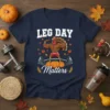 Muscular turkey lifting weights with "LEG DAY Matters" text, surrounded by fall leaves and pumpkins