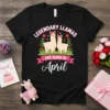 Black t-shirt with "Legendary Llamas Are Born In April" text, featuring two cute llamas with flower crowns and floral accents