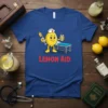 Blue t-shirt with "Lemon Aid" text and a cartoon lemon wearing a nurse hat holding a syringe and a drink