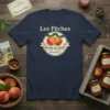 Les Pêches marché aux fruits FRANCE text with two ripe peaches graphic on a navy blue t-shirt