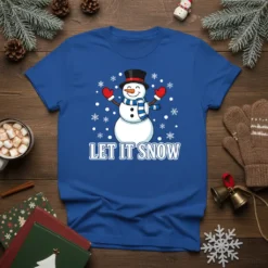 Let It Snow quote with a cute snowman wearing a hat and scarf, surrounded by snowflakes on a blue t-shirt