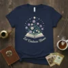 Let Kindness Bloom t-shirt design with an open book and colorful flowers, promoting positivity and inspiration