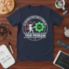 T-shirt with the quote "LET ME DROP EVERYTHING TO WORK ON... YOUR PROBLEM!" featuring a cartoon character fixing a gear