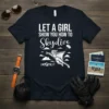 White text "Let a Girl Show You How to Skydive" on a navy t-shirt with a graphic of a woman