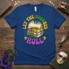 Blue t-shirt with "LET THE BOOBBS ROLL" text and stack of books adorned with Mardi Gras beads