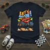 Let's Blaze! text with a cartoon monster truck jumping over ramps on a dark blue t-shirt