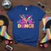 LET'S DANCE text in vibrant pink and orange with retro graphics, on a blue t-shirt