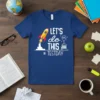 Let's Do This Test Day t-shirt with a rocket, books, and goal icon in white and yellow