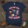 Let's Get This Party Crackin! text with three dancing nutcracker characters and cracked walnuts on a navy blue t-shirt