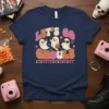 Let's Go Ghouls Halloween t-shirt with retro ghosts and playful typography in orange, pink, and cream colors