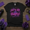 Black t-shirt with "LET'S GO PURPLE" in bold pink and purple lettering with an upward arrow graphic