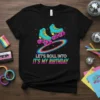 Let's Roll Into It's My Birthday text with retro teal roller skates graphic on a black t-shirt