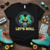 Black t-shirt with "LET'S ROLL" text, featuring teal roller skates and a disco ball, surrounded by colorful concentric circles