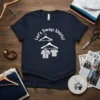 Let's Swap Shirts! text with graphics of shirts on hangers, dark navy t-shirt design