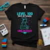Level 100 Days of School Unlocked text with retro arcade game and controller graphic on a black t-shirt