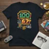 Black t-shirt featuring pixelated "Level 100 Survived 67 Bonus Rounds" text with gaming icons like chests, controllers, and hearts