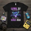 Level 12 Unlocked Awesome Since 2010 t-shirt with gaming console, controllers, and fireworks graphic