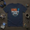Level 7 Unlocked text and video game controller graphic on a navy t-shirt, perfect for a 7th birthday gamer