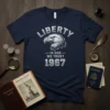 Navy t-shirt with "LIBERTY IN GOD WE TRUST 1967" text and a detailed eagle graphic, patriotic American design