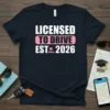 Licensed To Drive Est 2026 text design with a car graphic, printed on a navy t-shirt