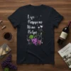 Life Happens Wine Helps quote on a navy t-shirt with wine bottle, grapes, and glasses graphic